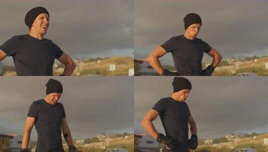 户外剧烈锻炼后戴着手套呼吸的疲惫运动员高清在线视频素材下载