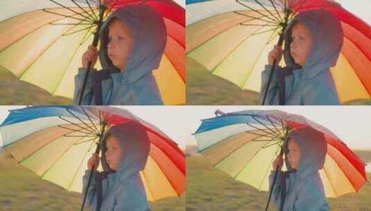 降雨持续时，男孩拿着雨伞高清在线视频素材下载