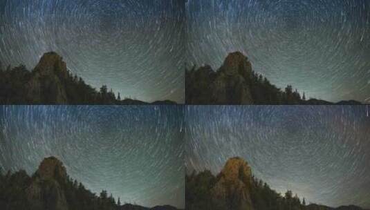 星空背景下山坡上云杉林的山峰高清在线视频素材下载