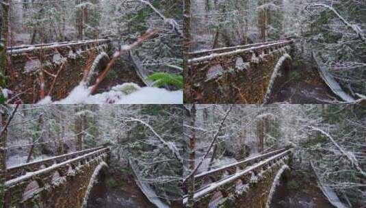 白雪皑皑的森林里的小溪上的桥高清在线视频素材下载