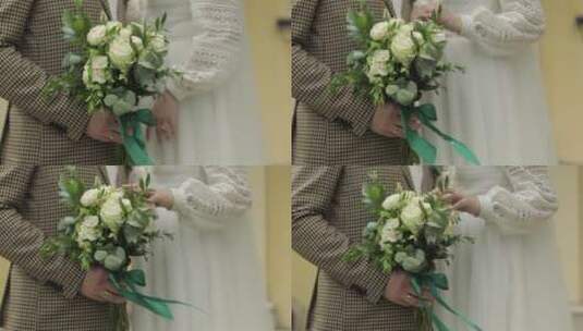 新郎和新娘的手抚摸着婚礼花束高清在线视频素材下载