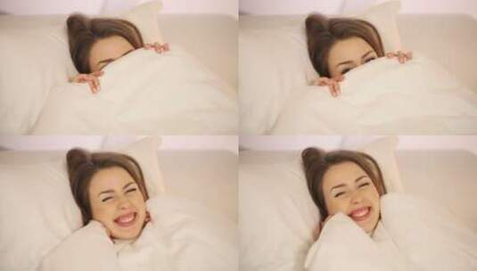 女孩躺在床上拉开毯子微笑的特写高清在线视频素材下载