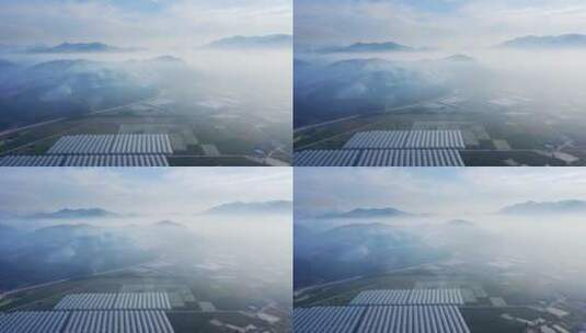 鸟瞰山谷雾中光伏太阳能电池板高清在线视频素材下载