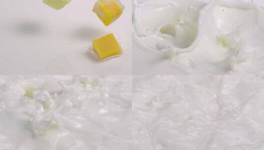芒果块掉入牛奶的特写镜头高清在线视频素材下载