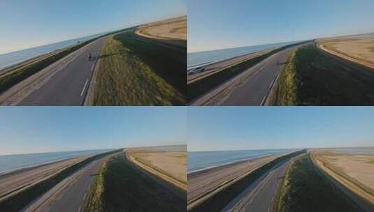 摩托车手在沿海公路行驶高清在线视频素材下载