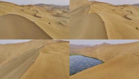 航拍沙漠沙脊上行走的人高清在线视频素材下载