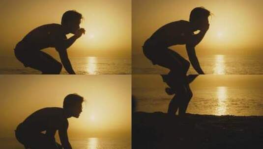 海滩黎明时一个男孩踢美式足球的剪影高清在线视频素材下载