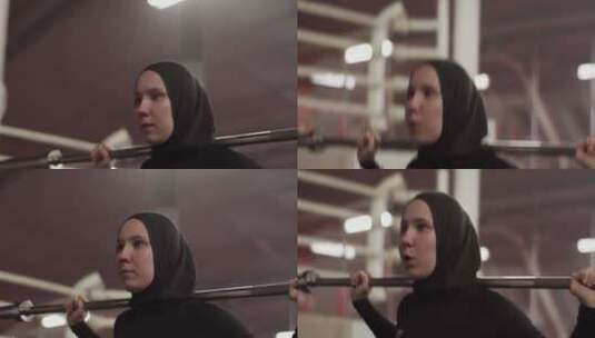 坚定的穆斯林女运动员用杠铃锻炼高清在线视频素材下载