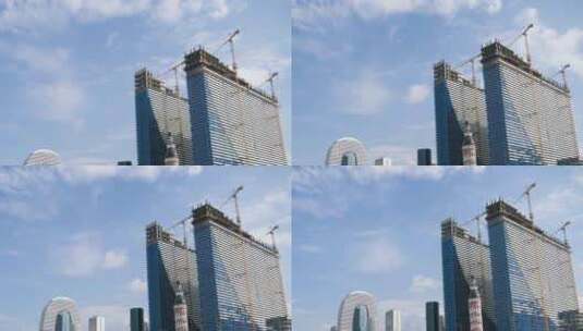 使用塔式起重机建造现代摩天大楼。延时。蓝天上移动的云高清在线视频素材下载