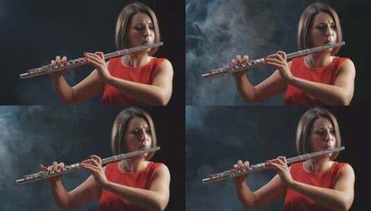 职业音乐家女性长笛演奏。烟雾工作室高清在线视频素材下载