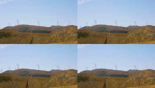 秋天山顶旋转的风力发电大风车高清在线视频素材下载