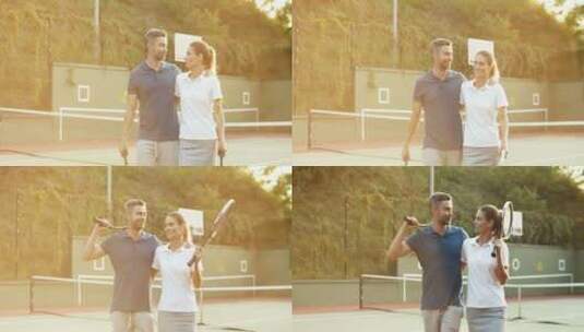 夫妇拿着网球拍走在运动场上高清在线视频素材下载
