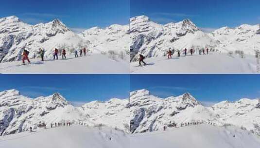 航拍滑雪者攀登雪山高清在线视频素材下载