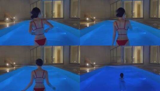 比基尼美女夜晚在游泳池游泳高清在线视频素材下载