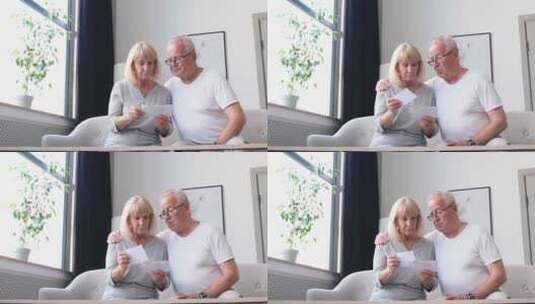 老年夫妇在家中看账单高清在线视频素材下载