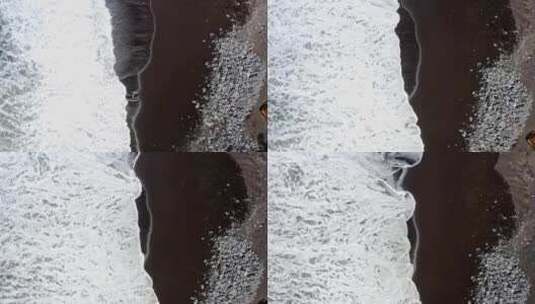 泡沫海浪冲刷着亚速尔群岛的黑色沙滩，垂直俯视图。高清在线视频素材下载