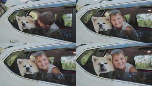 快乐的小男孩骑着他的秋田犬慢动作车高清在线视频素材下载