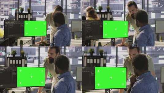 系统管理员与同事在绿屏PC上进行软件调试高清在线视频素材下载