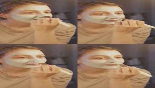 一个女人在脸上涂面霜高清在线视频素材下载