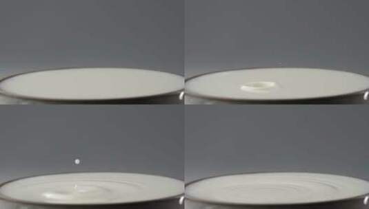 慢镜头特写拍摄一滴牛奶滴落到液面创意视频高清在线视频素材下载
