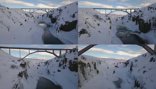 无人机在美丽的风景中飞过冰岛桥下的峡谷高清在线视频素材下载