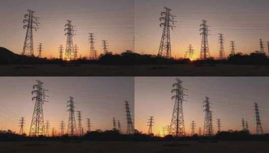 夕阳下电网高压电网铁塔航拍高清在线视频素材下载