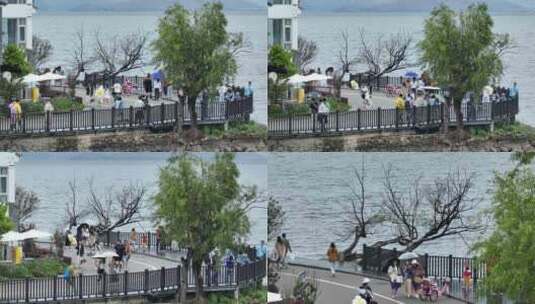 航拍云南大理洱海旅游人群游客雨天打伞高清在线视频素材下载